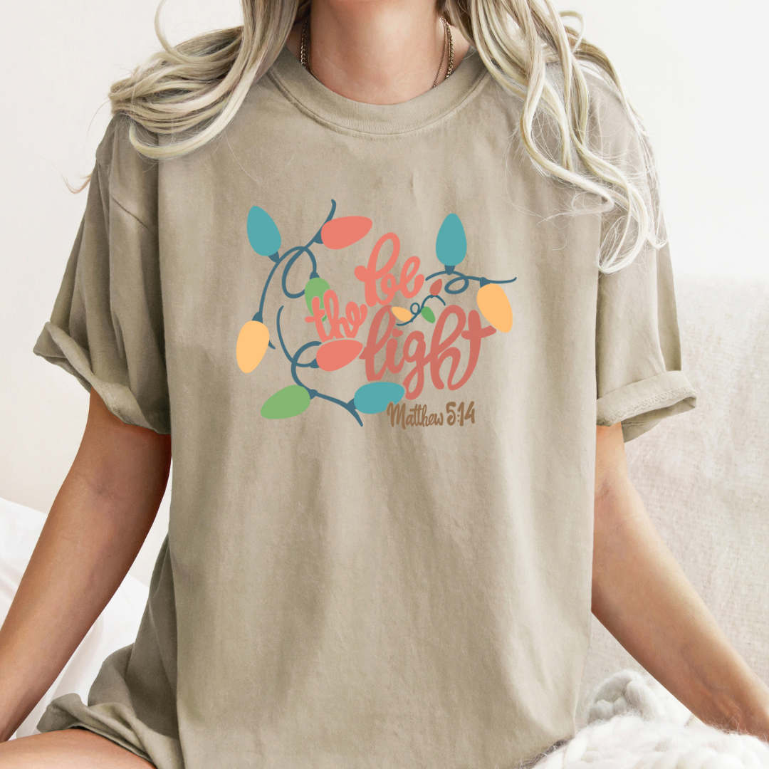 Be The Light Christmas Graphic Tee - Multiple Colors