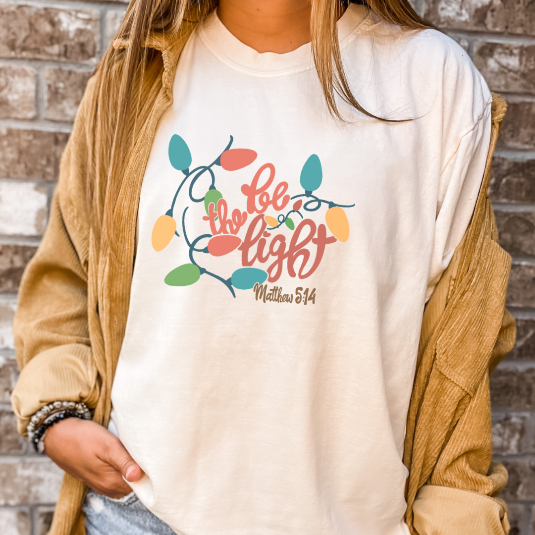 Be The Light Christmas Graphic Tee - Multiple Colors